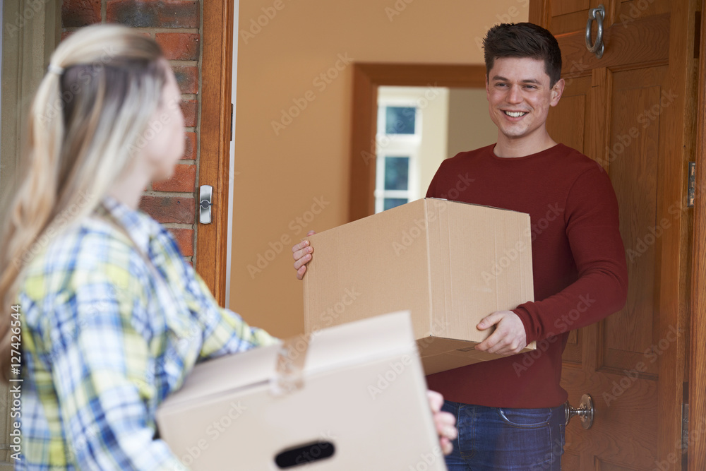 Young Couple Moving In To New Home Together Young Couple Moving In To New Home Together