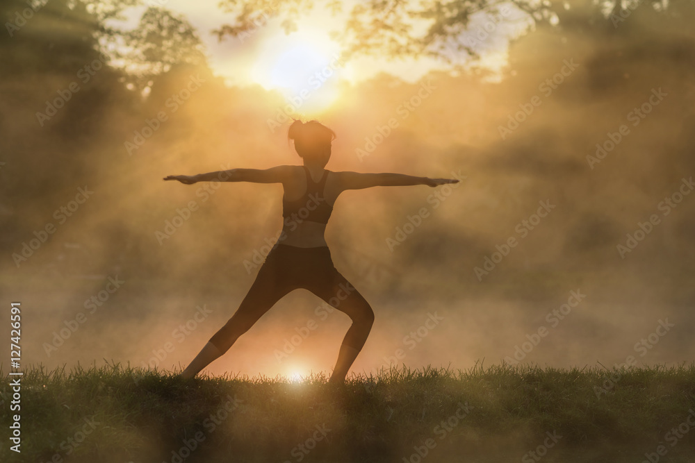 Young woman in silhouette practice yoga in a hot spring