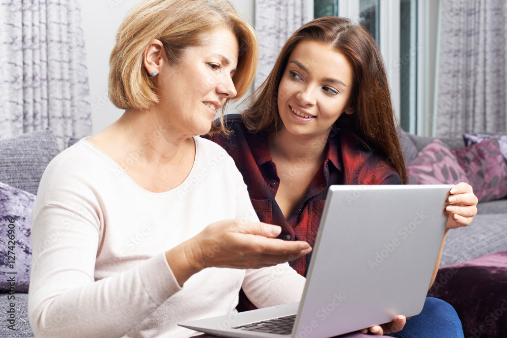 Teenage Daughter Showing Mother How To Use Laptop Computer Teenage Daughter Showing Mother How To Use Laptop Computer