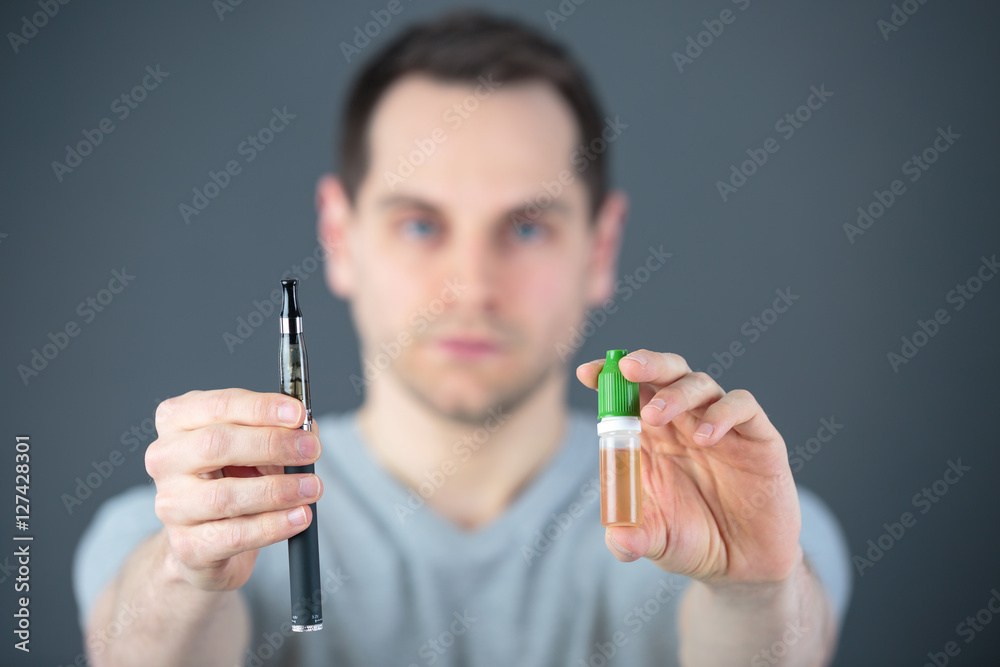 man in laboratory checking test tubes man in laboratory checking test tubes