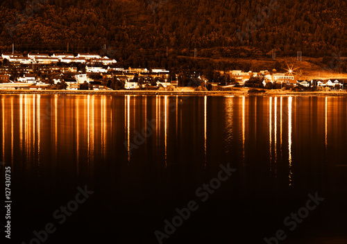 Sunset Tromso community with lights reflections background
