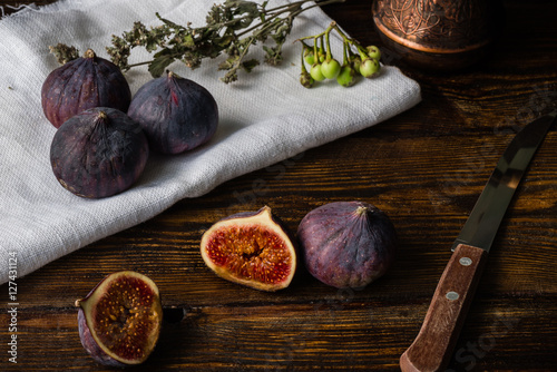Ripe and juicy figs lying on rustic table.