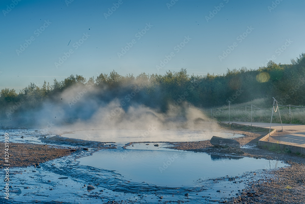 Last light before sunset highlights the steam rising form the Geysir in Iceland