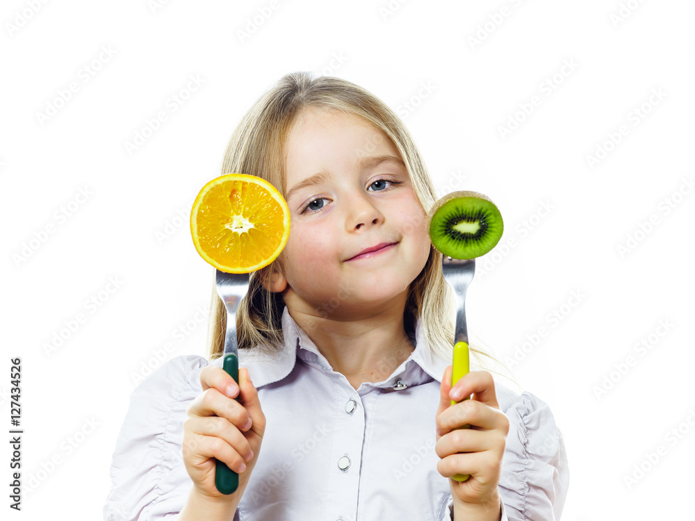 Funny little girl selecting between kiwi and orange Funny little girl selecting between kiwi and orange