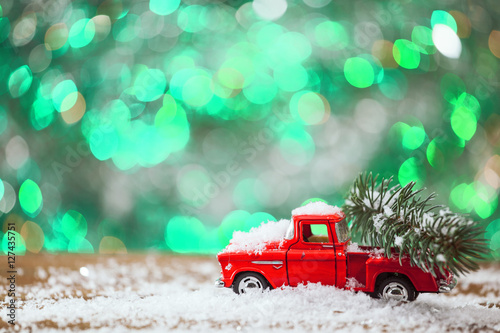 Christmas Toy Truck With Pine Tree On Wooden Table With Green Background.