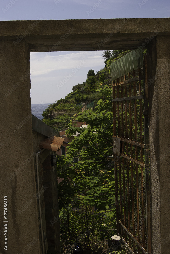 View of Cinque Terre Terraces through old iron garden gate View of Cinque Terre Terraces through old iron garden gate