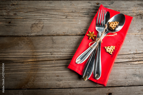 Wooden rustic table with cutlery and christmas decorations, Top view, copy space.