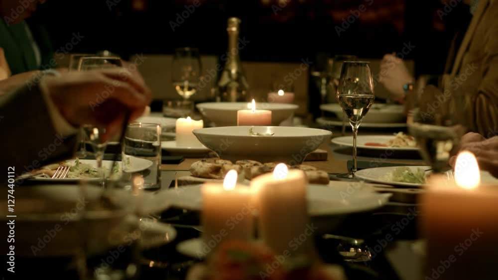 People having dinner at a restaurant.
People having dinner at a restaurant.
