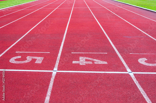 Numbers starting point on red running track,running track and green grass,Direct athletics Running track at Sport Stadium © rawintanpin