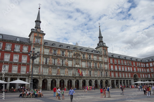  Tourist on mayor square "Plaza Mayor" in historical center of Madrid in a cloudy summer day. Spain