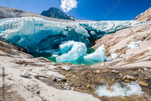 Water flows under the Aletsch glacier, which melts photo