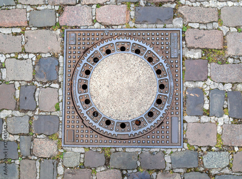 Photography Manhole cover on pavement with patterns, Amsterdam