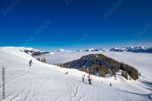 Skiiers on the ski slopes in Kitzbühel ski resort in Tyrolian Alps, Austria