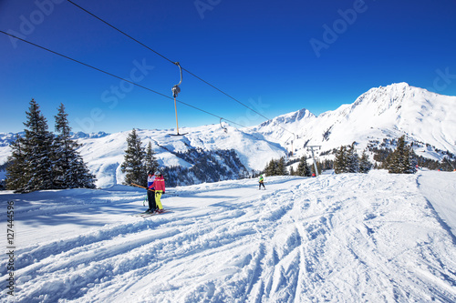 Skiers on the lift in Kitzbühel ski resort, Tyrolian Alps, Austria