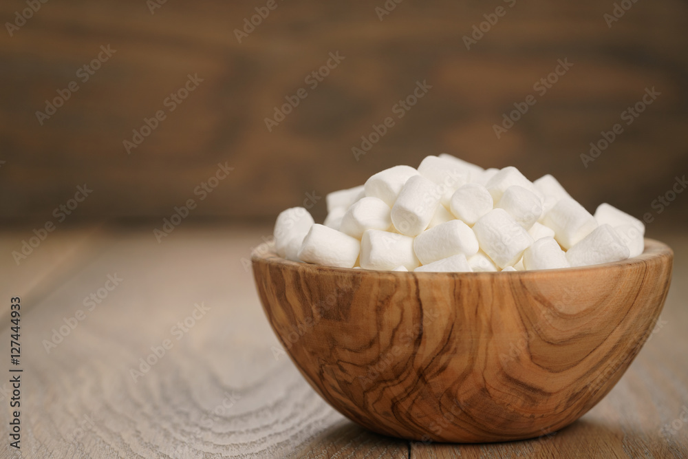 white marshmallows in wooden bowl on table white marshmallows in wooden bowl on table