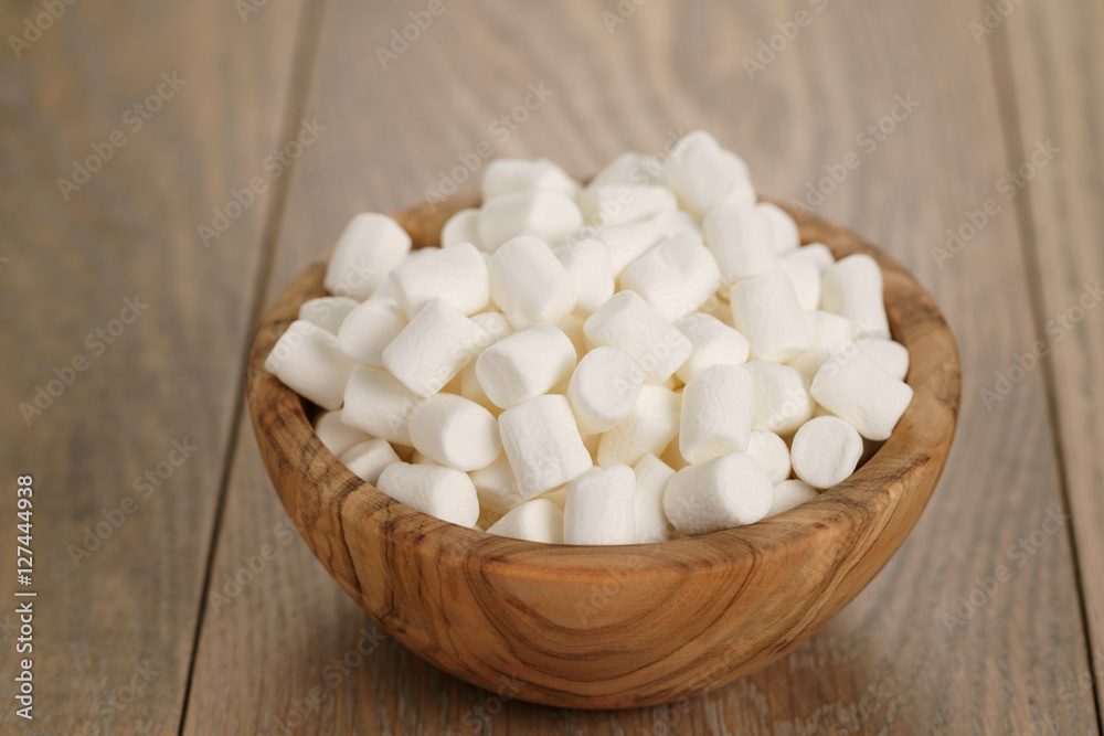 white marshmallows in wooden bowl on table white marshmallows in wooden bowl on table