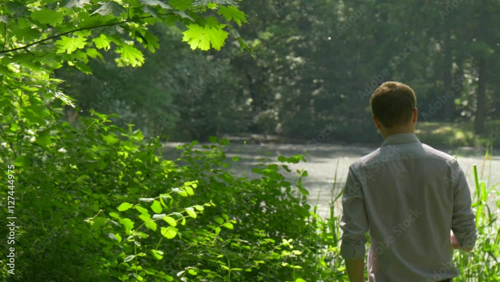 Tourist Walking Among Green Lush Bushes Looking at the Landscape Resting in Park Green Trees Freshness Sunlight Man Spends Weekends Vacations in Spring