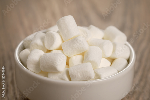 white marshmallows in white bowl on table