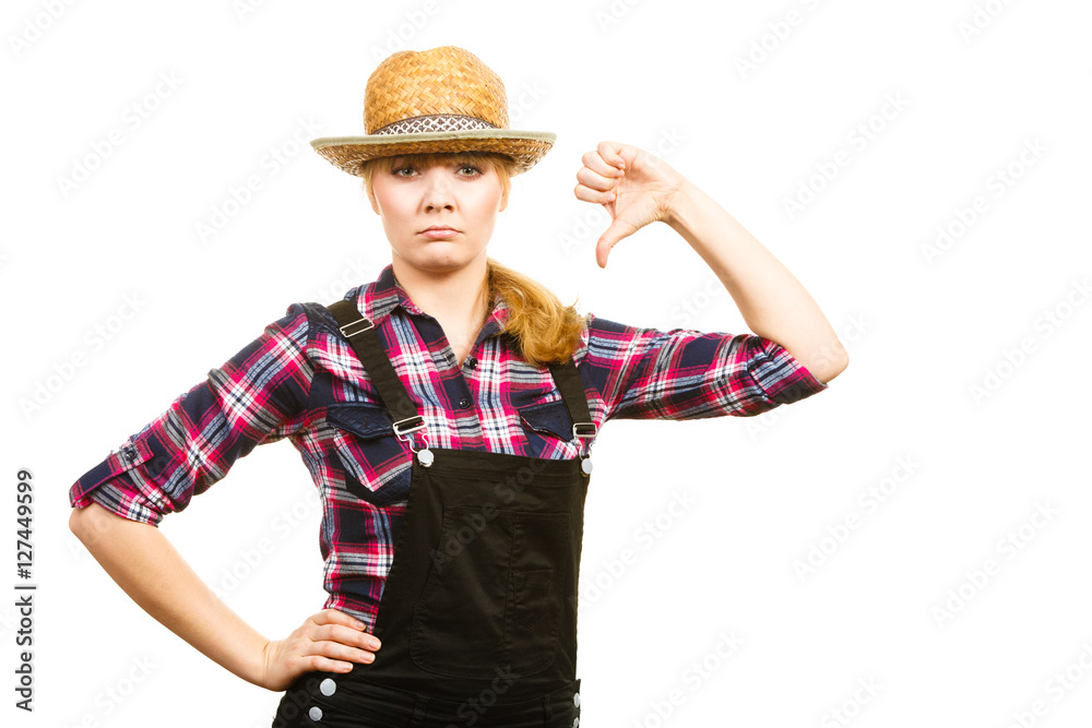 Woman in dungarees showing thumb down Woman in dungarees showing thumb down