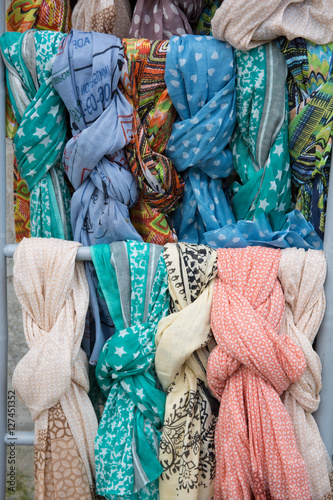 The colored silk scarfs in rows in market © OceanProd