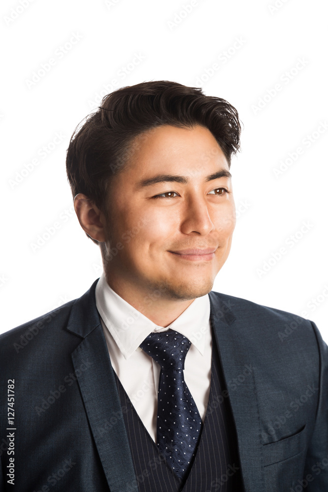 Handsome and well dressed businessman in a suit, tie and vest, standing against a white background smiling towards camera. Handsome and well dressed businessman in a suit, tie and vest, standing against a white background smiling towards camera.