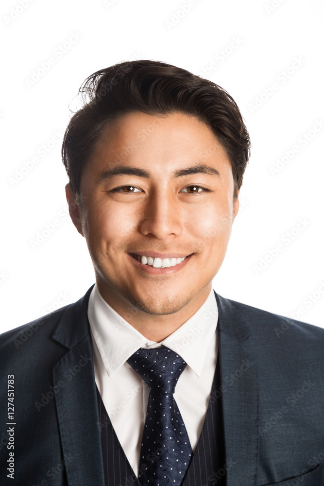 Handsome and well dressed businessman in a suit, tie and vest, standing against a white background smiling towards camera. Handsome and well dressed businessman in a suit, tie and vest, standing against a white background smiling towards camera.