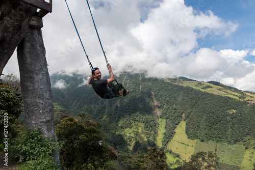 Man swings at Casa del Arbol, swing and treehouse vis-a-vis volcan Tungurahua