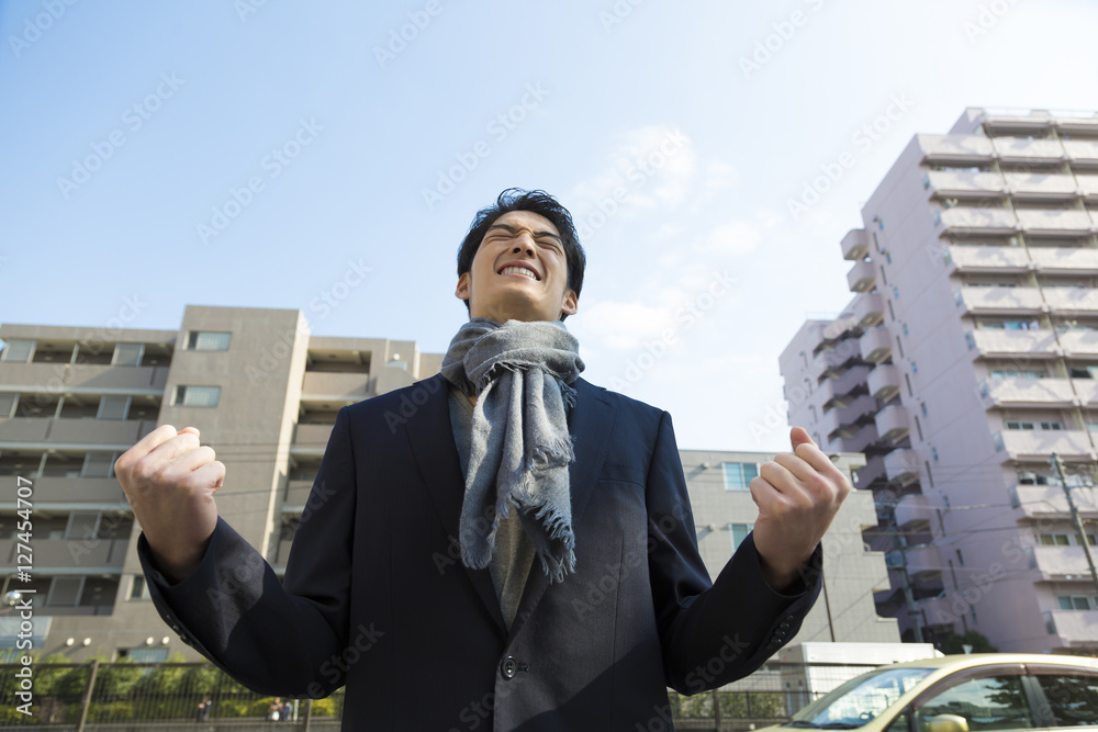 街中でガッツポーズをする男性 両手 握り拳 屋外 渋谷区 空 見上げる Stock 写真 Adobe Stock
