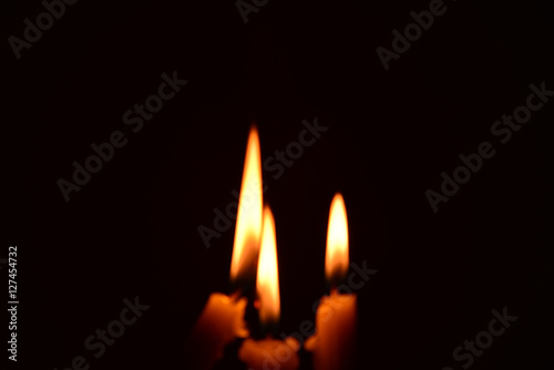 light candle burning brightly in the black background