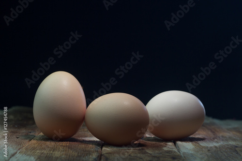 Eggs on wood background blue.