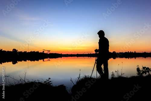  Silhouette of a photographer shooting sunset scene