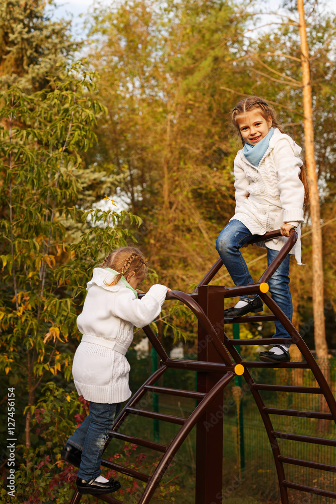 Sisters climbs stairs on playground. Sisters climbs stairs on playground.