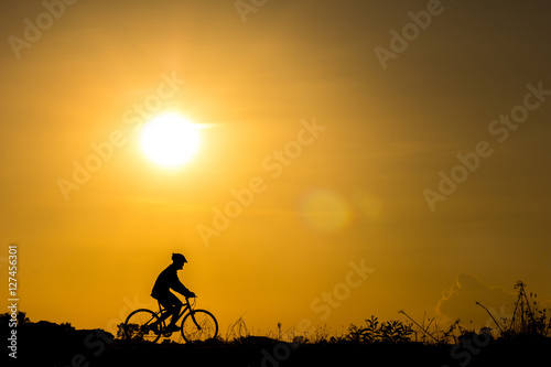 Silhouette of cyclist in motion