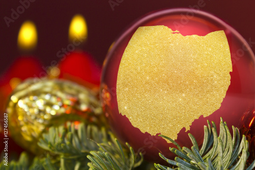 Red bauble with the golden shape of Ohio.(series)