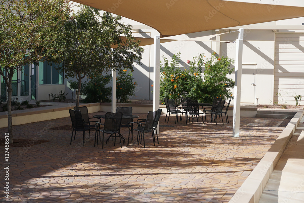 shielded outdoor steel lunch tables and chairs outside office building