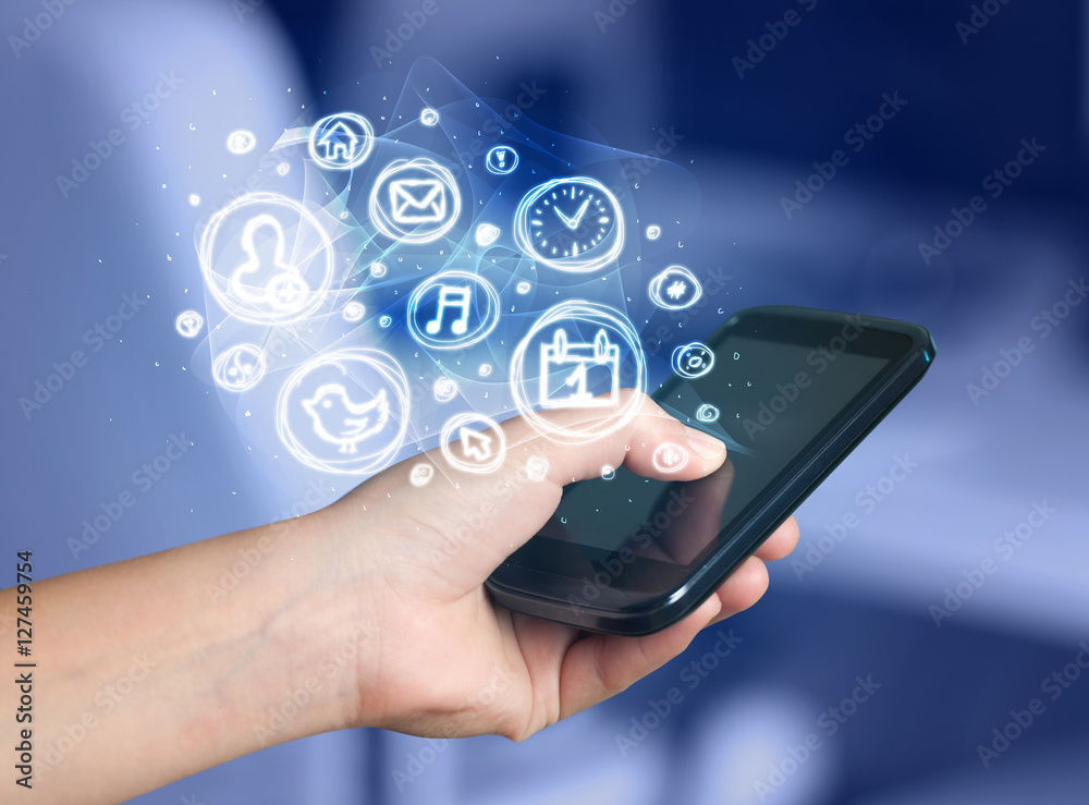 Hand holding smartphone with mobile app choices Hand holding smartphone with mobile app choices