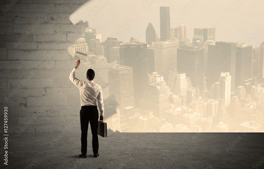 Salesman painting city scape on wall Salesman painting city scape on wall
