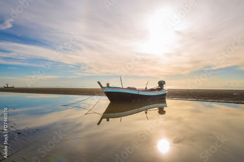 Boat on the beach at sunrise time