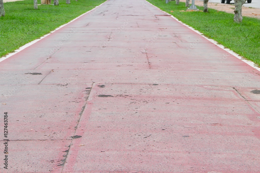 Obraz premium Running track old rubber coating shabby and cracked surface
