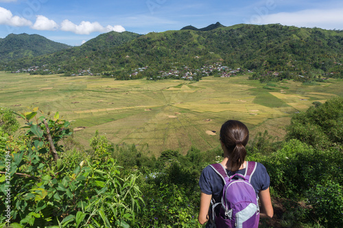A backpacker and the lingko spider web rice fields, Cancar, Ruteng, Nusa Tenggara, Indonesia photo