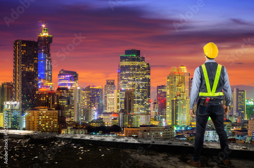 Engineer holding yellow helmet