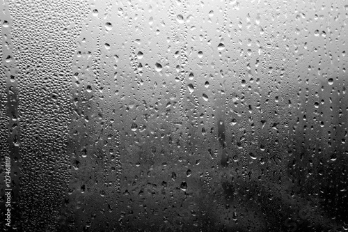 Rain drops on window close-up in black and white