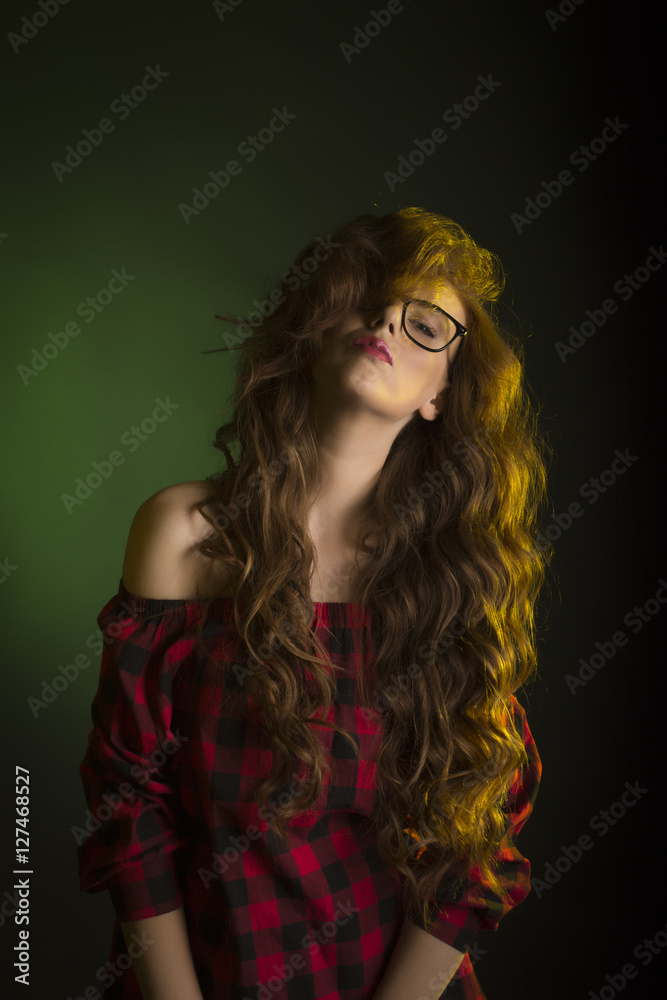 Confident young model wearing glasses. Studio portrait