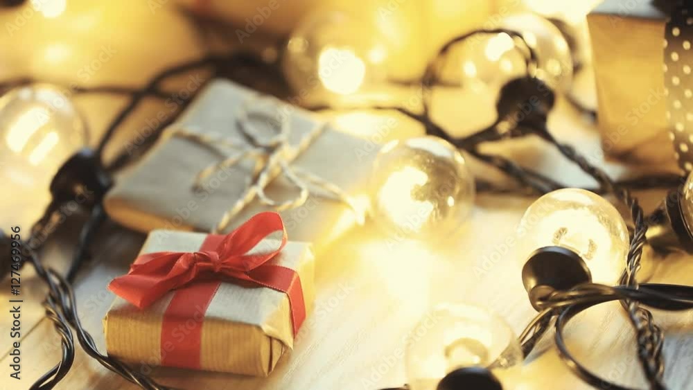 Christmas gift and lights on wooden background Christmas gift and lights on wooden background