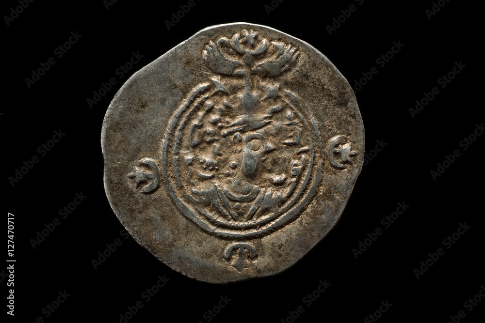 Ancient silver Sassanian coin isolated on black