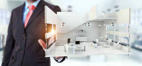Businessman touching white 3D rendering apartment with his finge