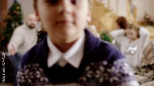 familes waving at camera at christmas party photo