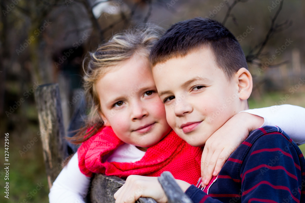 Little brother and his sister outdoor portrait. It is beautifull Little brother and his sister outdoor portrait. It is beautifull