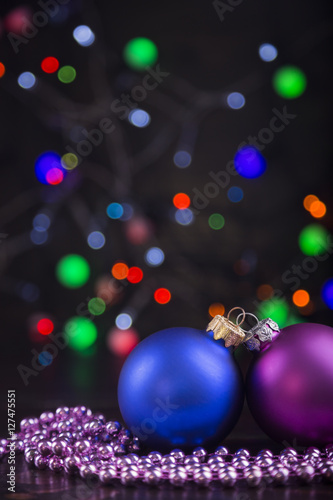 Two Christmas balls and beads with garland lights