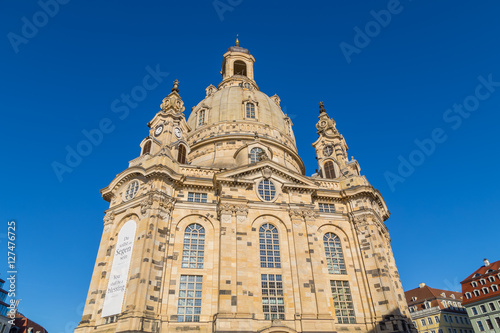 Famous Frauenkirche in the city center of Dresden, Germany in the morning sun with blue sky above.